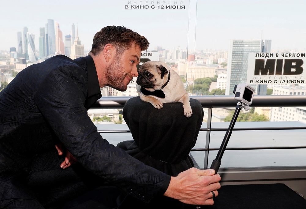 Chris Hemsworth poses for a selfie with a dog during a photocall for the film u00e2u20acu02dcMen in Black: Internationalu00e2u20acu2122 ahead of its Russian premiere, in Moscow, Russia June 6, 2019. u00e2u20acu201d Reuters pic       