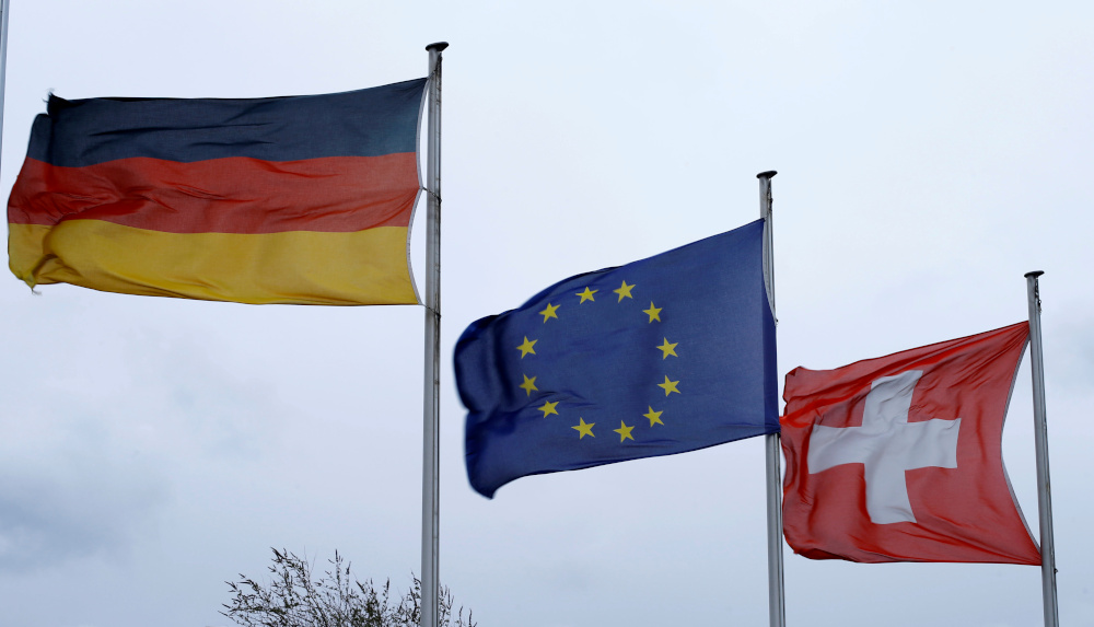 An EU flag flies between the Swiss and German national flags near the German-Swiss border in Rheinfelden, Germany, March 11, 2019. u00e2u20acu201d Reuters pic 