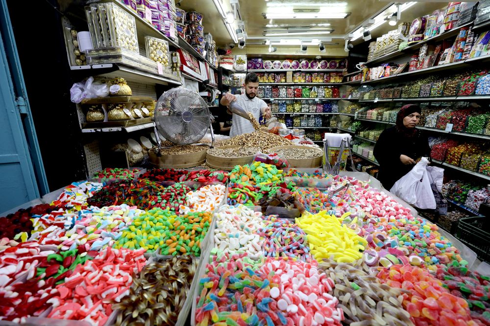 A Palestinian woman stands next to sweets for sale as Palestinians shop ahead of the Muslim holiday of Eid al-Fitr, which marks the end of the holy fasting month of Ramadan, in Jerusalemu00e2u20acu2122s Old City June 4, 2019. u00e2u20acu201d Reuters pic