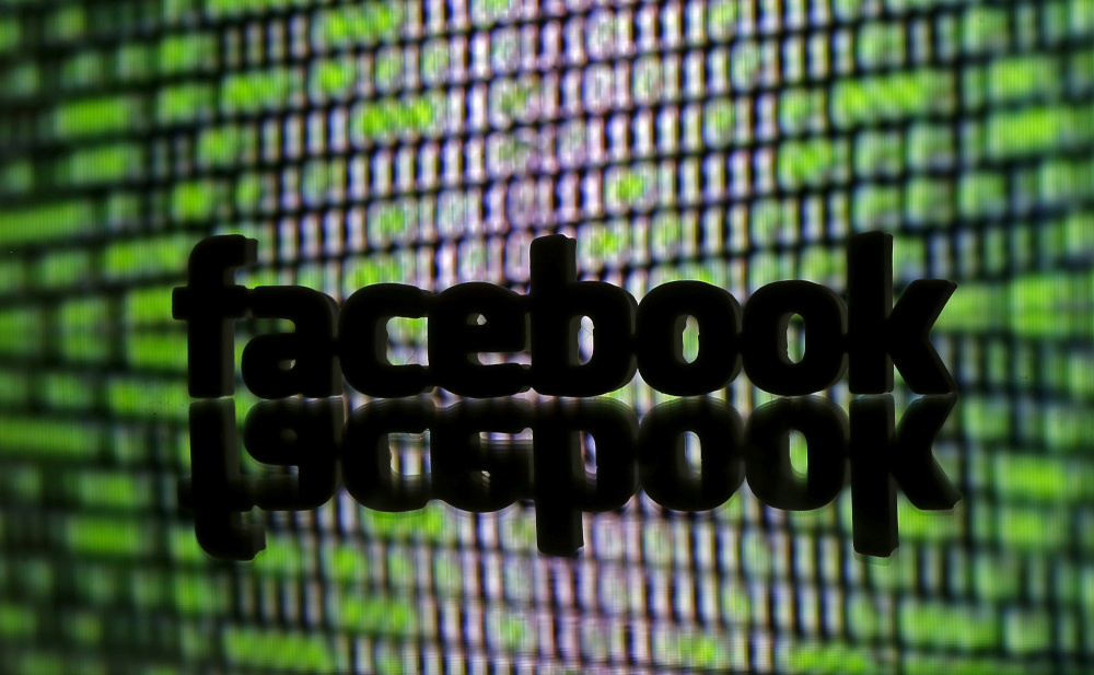 A 3D-printed Facebook logo is seen in front of a displayed cyber code in this illustration taken March 22, 2016. u00e2u20acu201d Reuters pic 