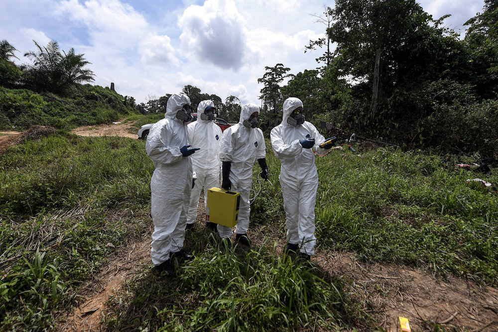Hazmat personnel from the Kelantan Fire and Rescue Department collect air samples at the Kuala Koh Orang Asli settlement in Gua Musang June 11, 2019. u00e2u20acu201d Bernama pic