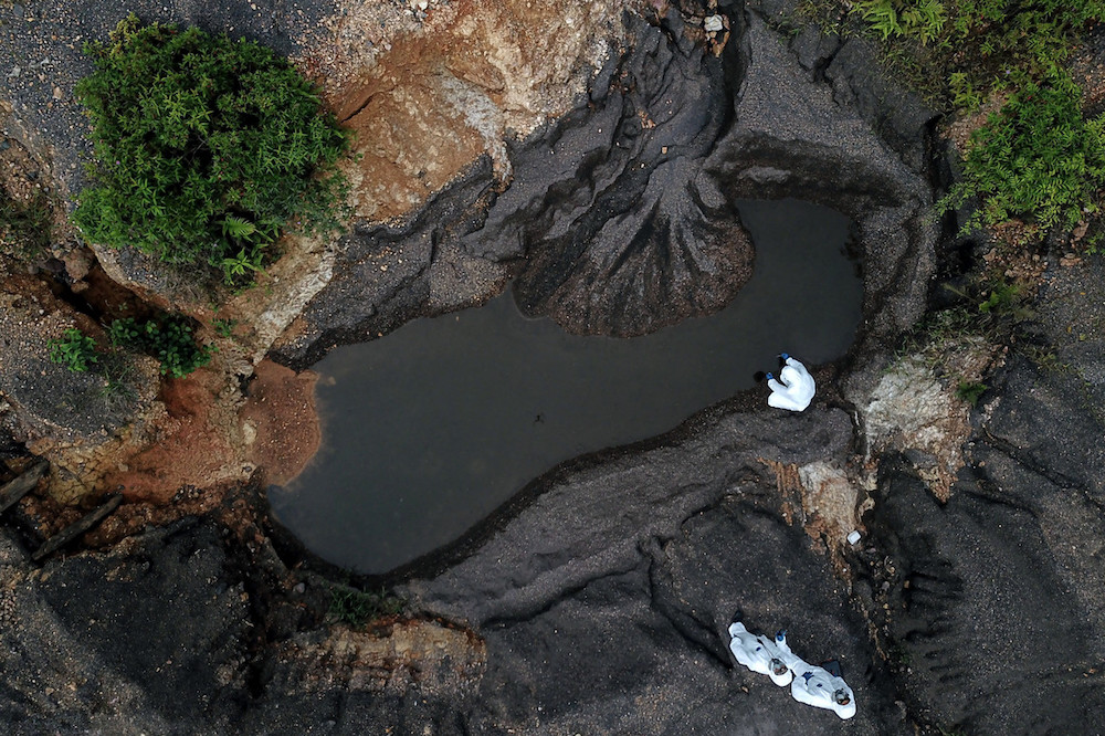Hazmat personnel from the Kelantan Fire and Rescue Department take water samples at the Kuala Koh Orang Asli settlement in Gua Musang June 11, 2019. u00e2u20acu201d Bernama pic