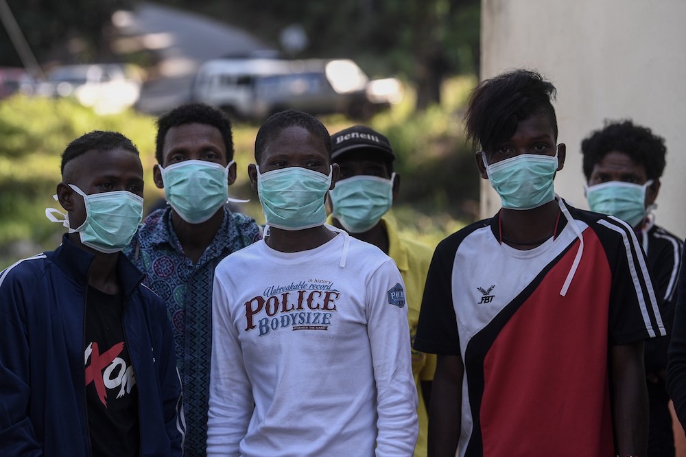 Members of the Batek tribe wear face masks at their settlement in Kuala Koh June 14, 2019. u00e2u20acu201d Bernama pic