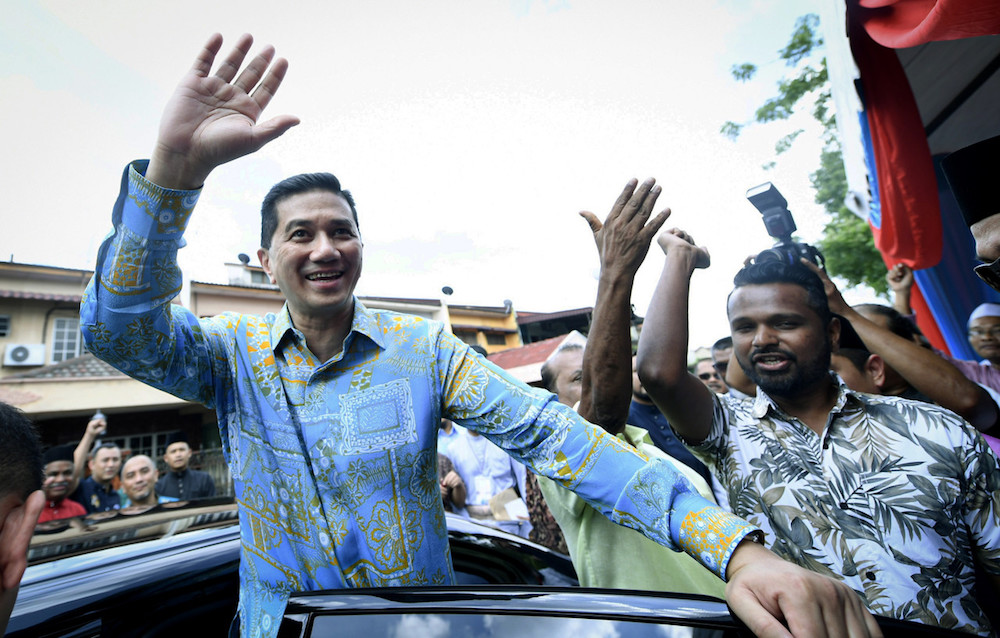 Datuk Seri Azmin Ali waves as he leaves an Aidilfitri open house in Gombak June 16, 2019. u00e2u20acu201d Bernama pic