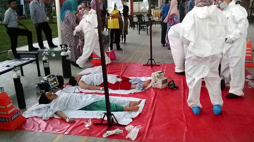 Emergency services staff attend to students with reported breathing difficulties at Sekolah Agama Taman Mawar in Pasir Gudang June 20, 2019. u00e2u20acu201d Bernama pic