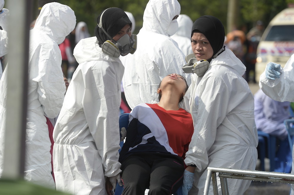 Fire and Rescue Department personnel come to the aid of a student at Sekolah Menengah Kebangsaan (SMK) Tanjung Puteri Resort in Pasir Gudang June 24, 2019. u00e2u20acu201d Bernama pic