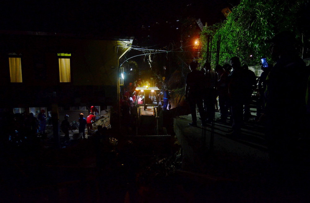 Fire and Rescue Department personnel search for victims of a landslide in Tanjung Bungah, George Town June 25, 2019. u00e2u20acu201d Bernama pic