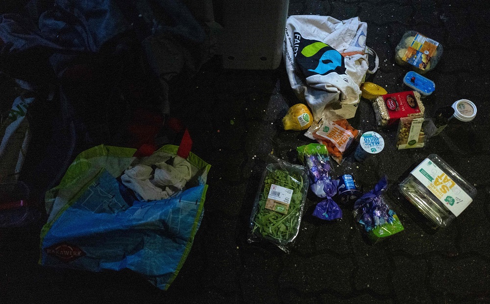 Food items retrieved from the trash by a dumpster diver lie on the ground in the back lot of a supermarket in Berlin May 17, 2019. — AFP pic