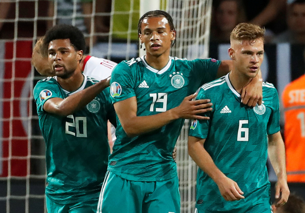 Germanyu00e2u20acu2122s Leroy Sane celebrates scoring their first goal with Serge Gnabry and Joshua Kimmich during the Euro 2020 Group C qualifier against Belarus June 8, 2019. u00e2u20acu201d Reuters pic 
