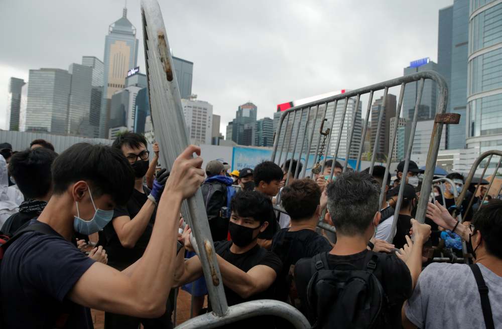 Demonstrators remove metal barricades during protests against a proposed extradition bill in Hong Kong June 12, 2019. u00e2u20acu2022 Reuters pic