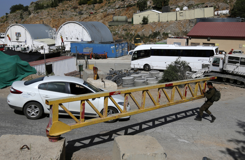 An Israeli soldier based in a military zone in a ski resort opens a gate, in Mount Hermon in the Iraeli-annexed Golan Heights from the Syrian side, June 2, 2019. u00e2u20acu201d AFP pic 