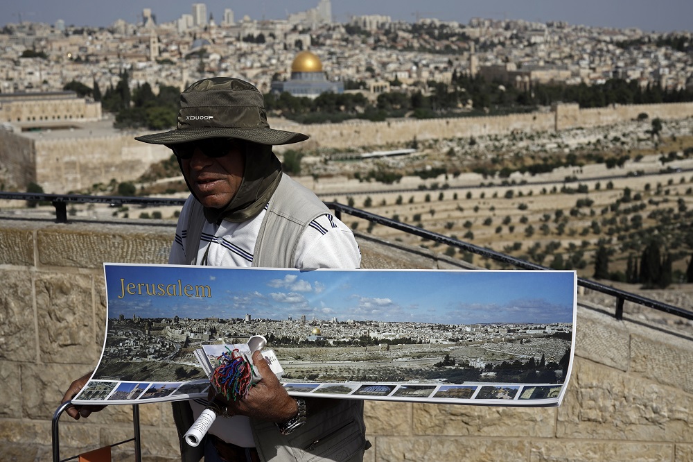 A street vendor at the Mount of Olives sells panoramic views of Jerusalemu00e2u20acu2122s Old City June 4, 2019. u00e2u20acu201d AFP pic   