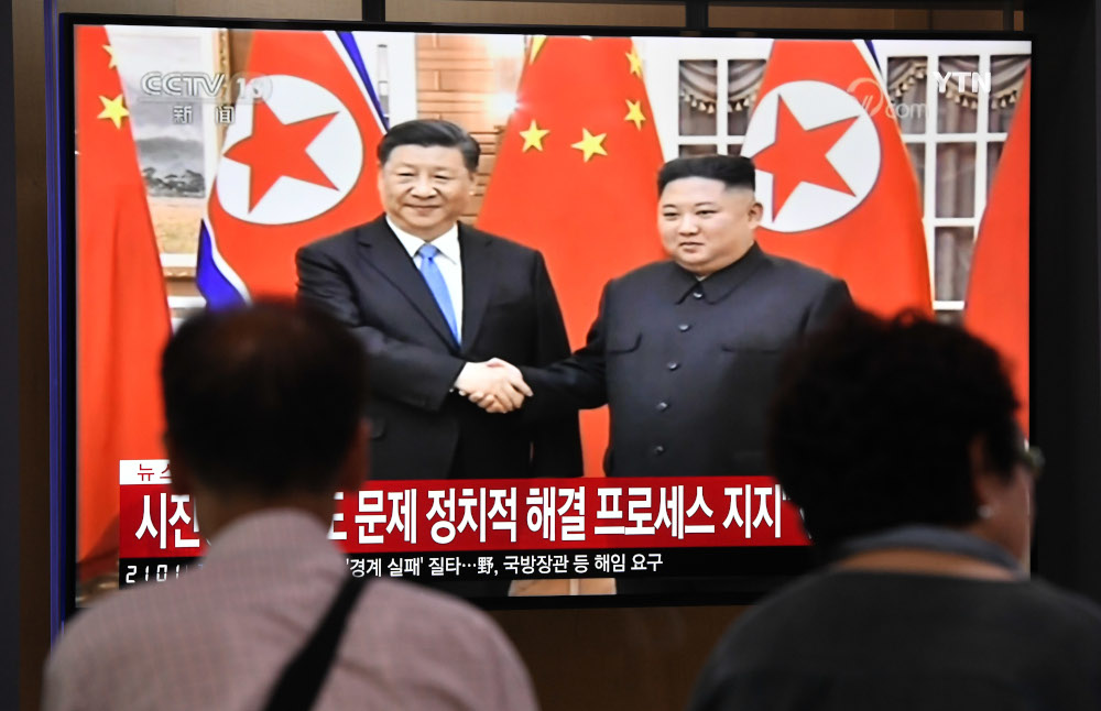People watch a television news screen showing North Korean leader Kim Jong-un shaking hands with Chinese President Xi Jinping, at Seoul railway station in Seoul June 20, 2019. u00e2u20acu201d AFP pic