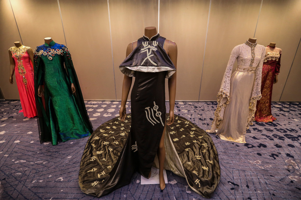 Some of KL Ho’s designs that incorporate zentangle patterns and ancient Chinese characters on a Cheongsam. — Picture by Firdaus Latif