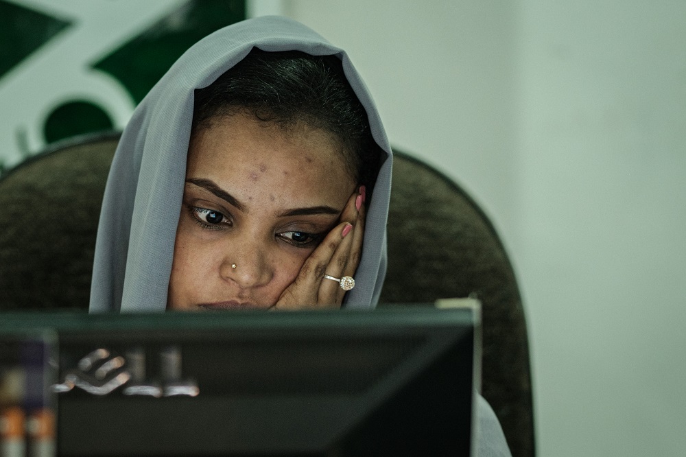 A Sudanese woman works at a travel agency in Khartoum on June 17, 2019 as businesses struggle to keep their services going after being hit by an internet blackout. u00e2u20acu201d AFP pic       