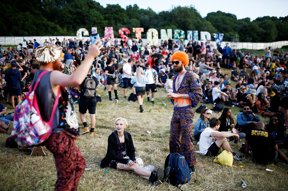Festival goers relax during sunset at Glastonbury Festival at Worthy Farm in Somerset, Britain June 26, 2019. u00e2u20acu201d Reuters pic   