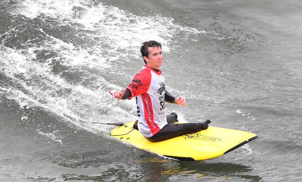 US military veteran Jordan Sisco, injured during his time in Afghanistan, gestures while riding a wave at the Operation Surf event on June 4, 2019 in Huntington Beach, California. u00e2u20acu2022 AFP pic        