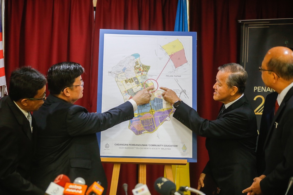 Penang Tzu Chi CEO Koay Chiew Poh, Penang Development Corporation deputy general manager Mohd Bazid Abd Kahar and Penang Chief Minister Chow Kon Yeow look at the projectu00e2u20acu2122s site map in George Town June 26, 2019. u00e2u20acu201d Picture by Sayuti Zainudin