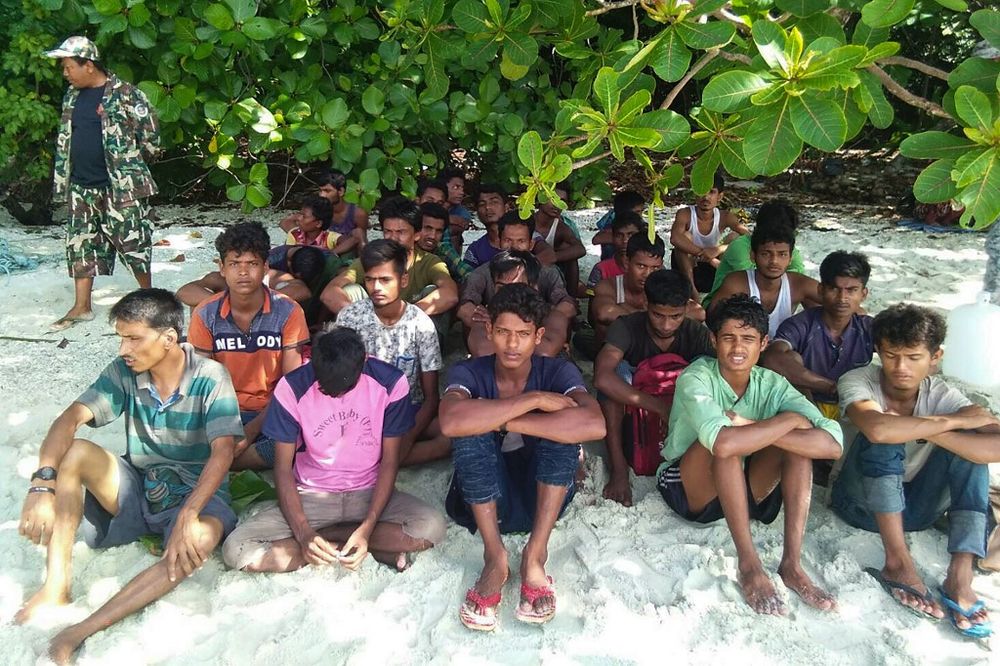 Picture taken on June 11, 2019 and released by Department of National Parks, Wildlife and Plant Conservation (DNP) shows a group of Rohingya Muslims sitting on the sand at the Tarutao Marine National Park on Rawi island, southern Thailand. u00e2u20acu201d AFP pic