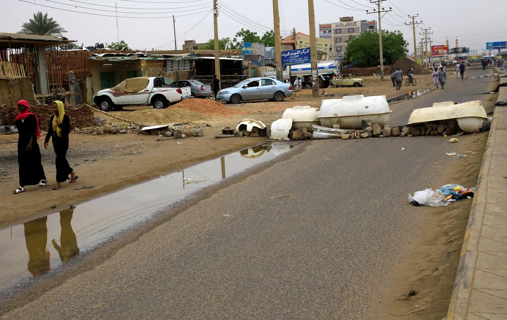 Women walk past a barricade erected on a street by Sudanese protesters, demanding that the countryu00e2u20acu2122s Transitional Military Council hand over power to civilians, in Khartoum, Sudan June 4, 2019. u00e2u20acu201d Reuters pic