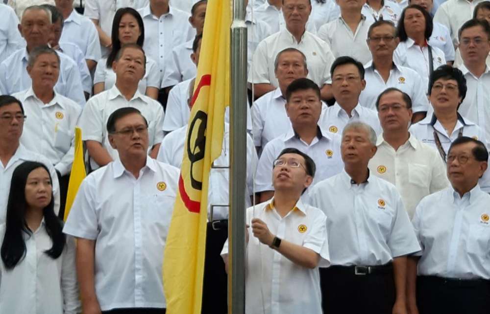 SUPP president Datuk Dr Sim Kui Hian raising the partyu00e2u20acu2122s flag to mark the 60th anniversary of the party, June 4, 2019. u00e2u20acu2022 Picture by Sulok Tawie