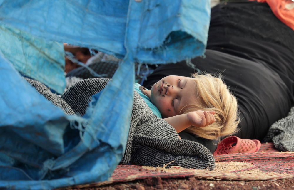A displaced Syrian child sleeps on a mat laid out on the floor in an olive grove in the town of Atmeh, Idlib province, Syria May 19, 2019. u00e2u20acu201d Reuters pic