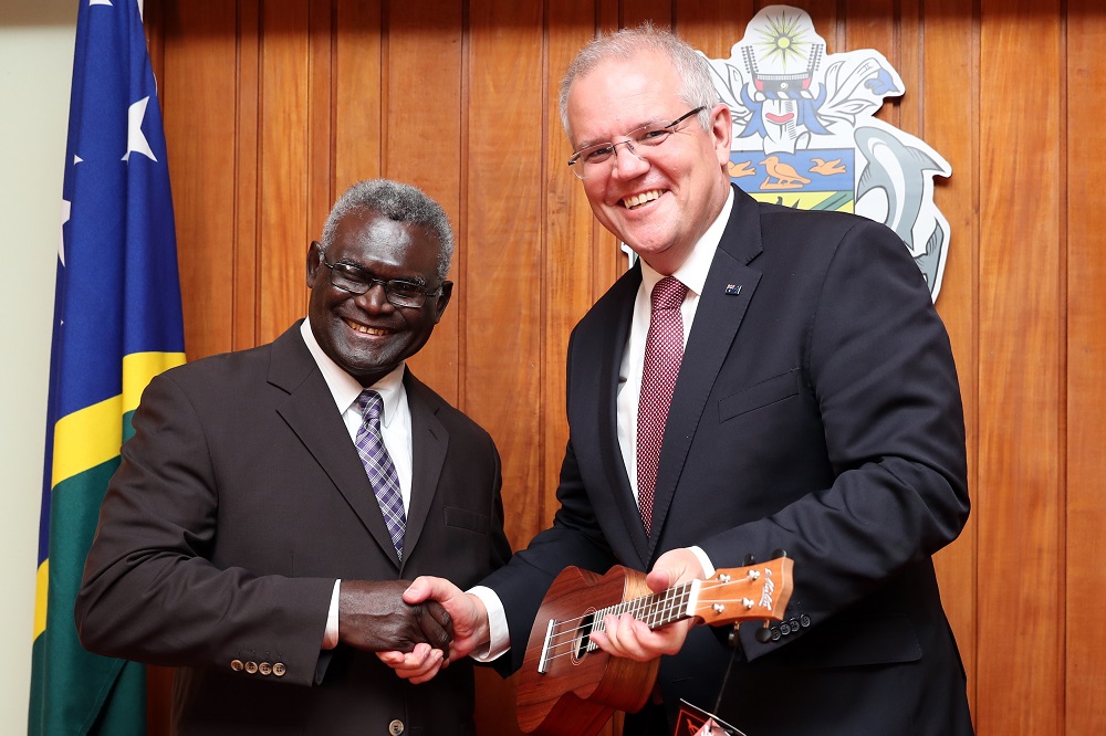 In this handout photograph taken and released on June 3, 2019, Australia's Prime Minister Scott Morrison (right) and his Solomons Islands counterpart Manasseh Sogavare exchange gifts in Honiara. u00e2u20acu201d Australian Prime Minister's Office/Adam Taylor/AFP pic 