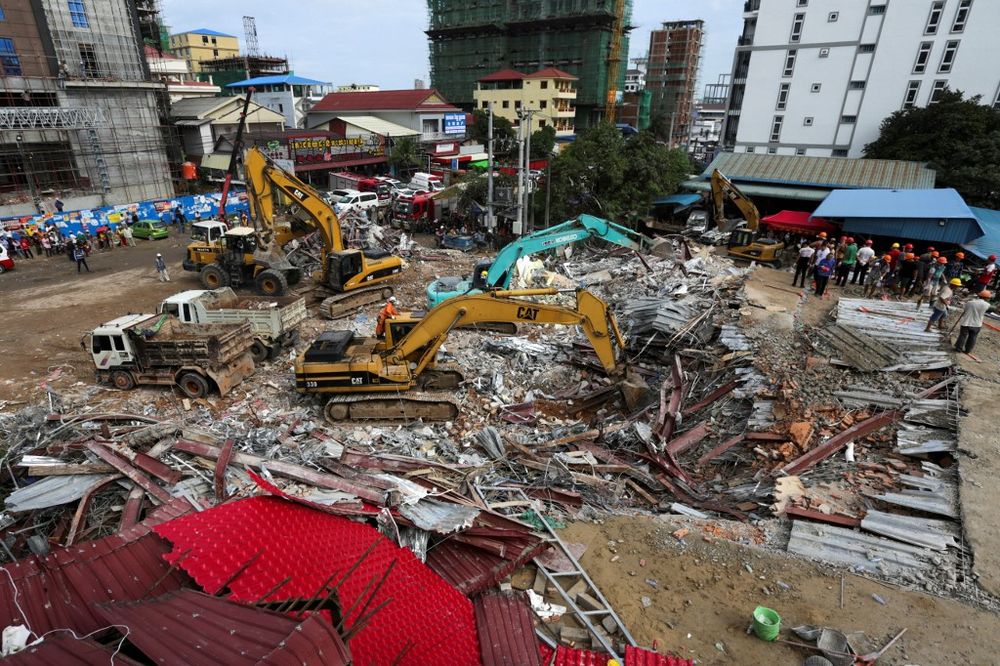 Rescue workers use earthmovers to clear debris as they search for victims a day after an under-construction building collapsed in Sihanoukville on June 23, 2019. u00e2u20acu201d AFP pic
