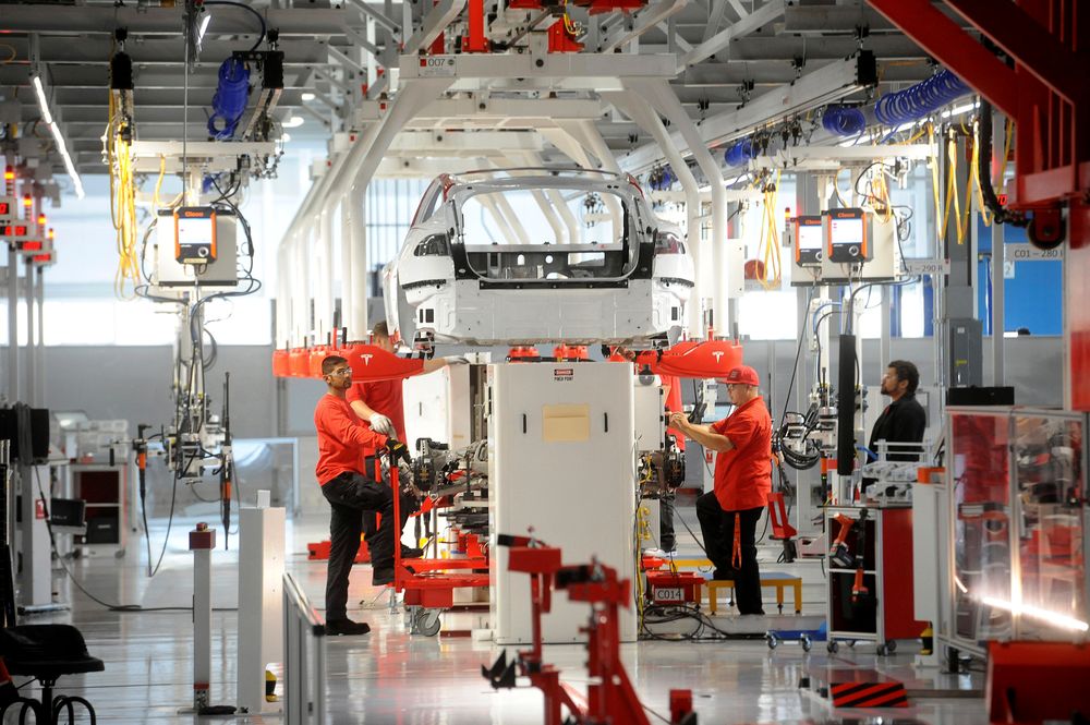 Tesla workers examine a Model S used for training and tool calibration at the companyu00e2u20acu2122s factory in Fremont, California, June 22, 2012. u00e2u20acu201d Reuters file pic