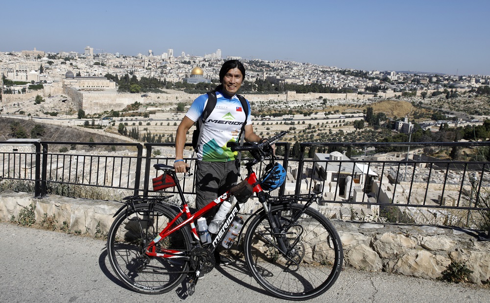 Taiwanese cyclist and world traveller Jacky Chen on the Mount of Olives overlooking the Old City of Jerusalem. u00e2u20acu2022 AFP pic       