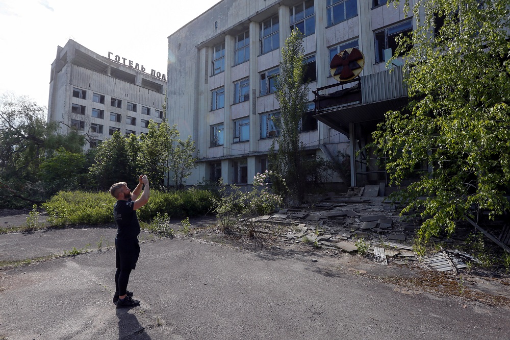 A visitor takes photos of a building in the abandoned city of Pripyat, near the Chernobyl nuclear power plant, Ukraine June 2, 2019. u00e2u20acu201d Reuters pic  
