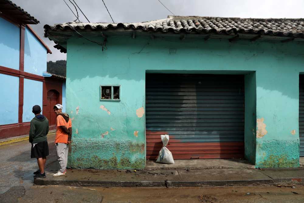 Locals stand in a corner beside a bag with coffee beans used for bartering, in Guarico, Venezuela April 24, 2019. u00e2u20acu2022 Reuters pic