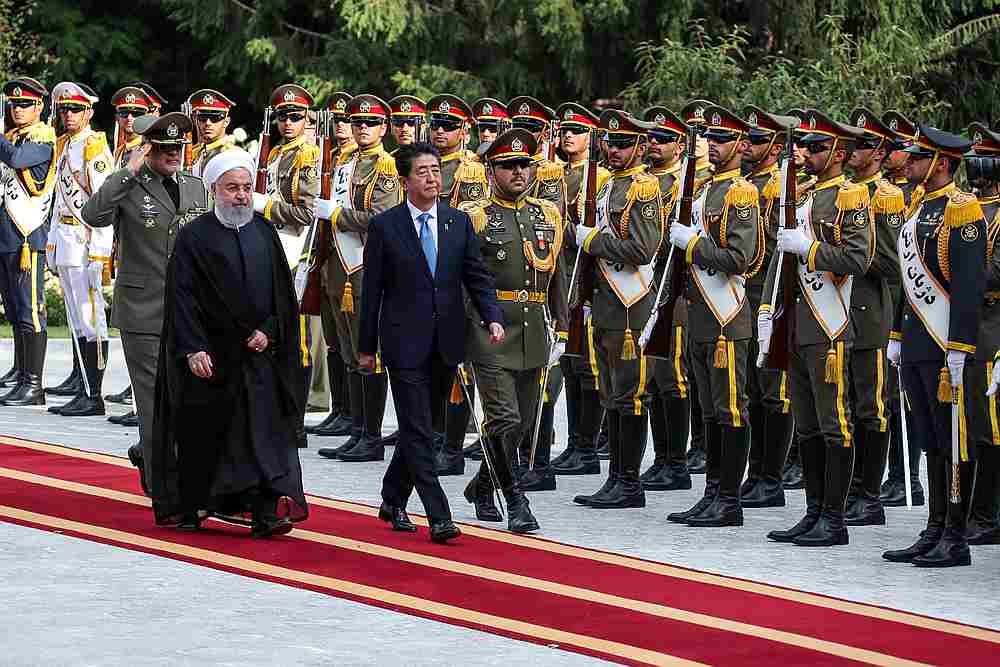 Iranian President Hassan Rouhani walks with Japan's Prime Minister Shinzo Abe during a welcome ceremony in Tehran, June 12, 2019. u00e2u20acu201d Official President website handout via Reuters