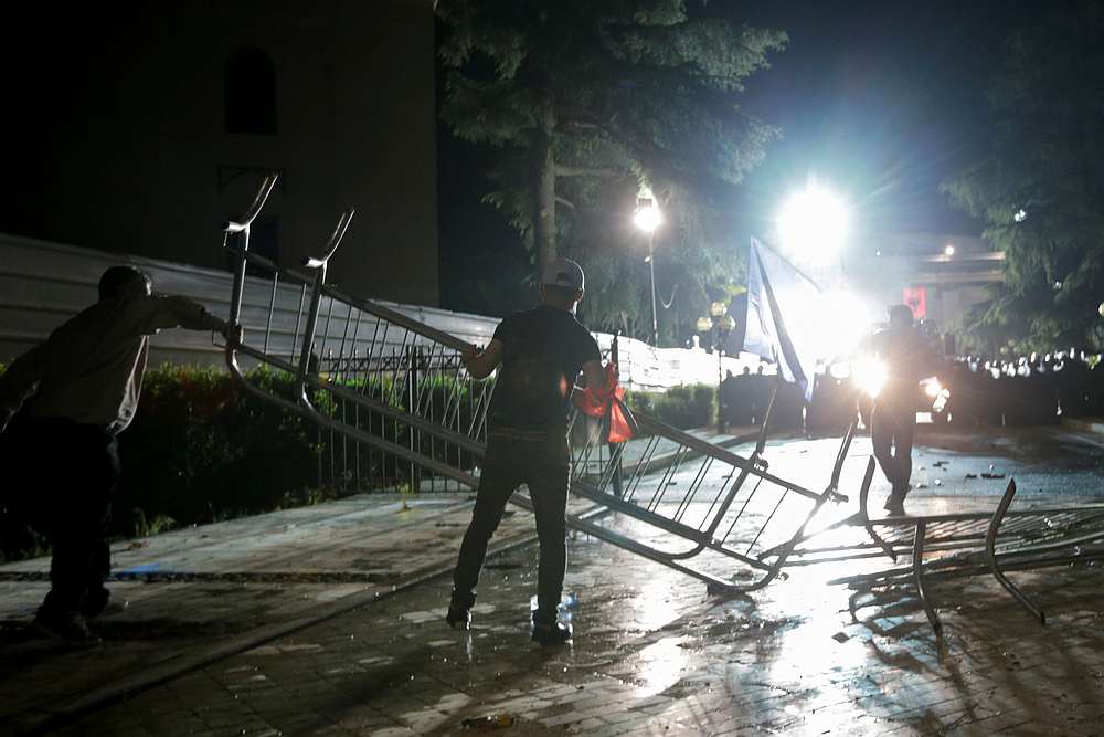 Opposition supporters dismantle barricades set by the riot police officers outside Parliament building during an anti-government protest in Tirana, Albania, June 8, 2019. u00e2u20acu201d Reuters pic