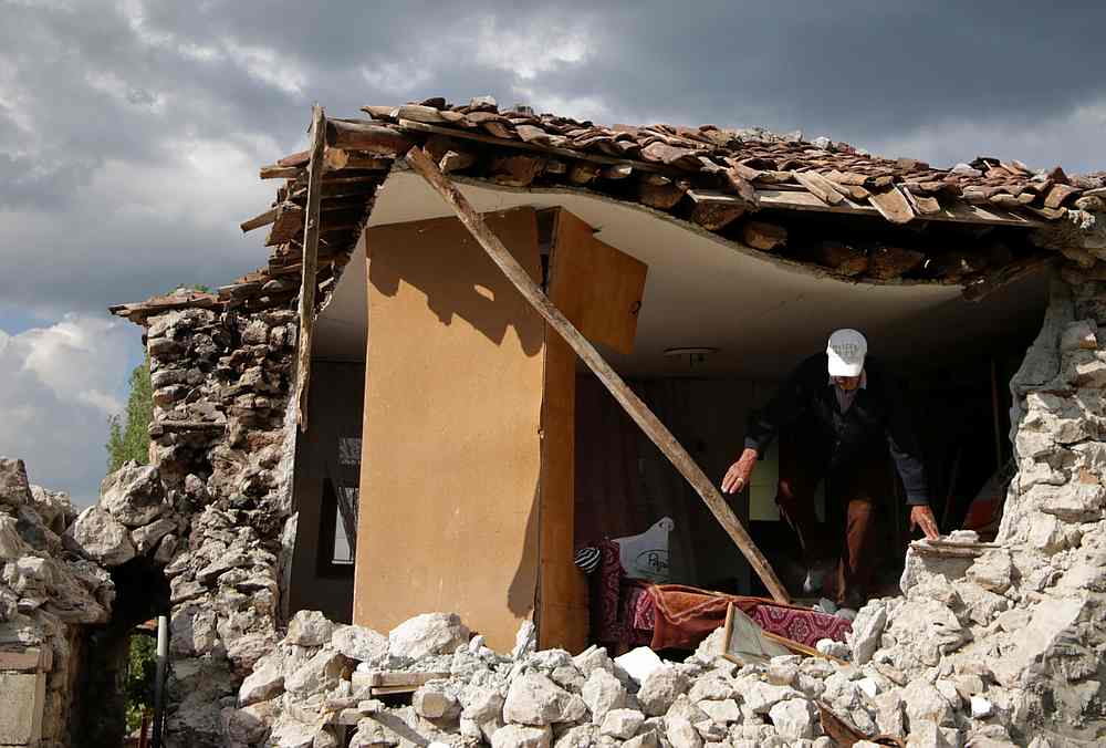 A man leaves a damaged building after an earthquake stroked the area in Floq, Albania, June 1, 2019. u00e2u20acu201d Reuters pic