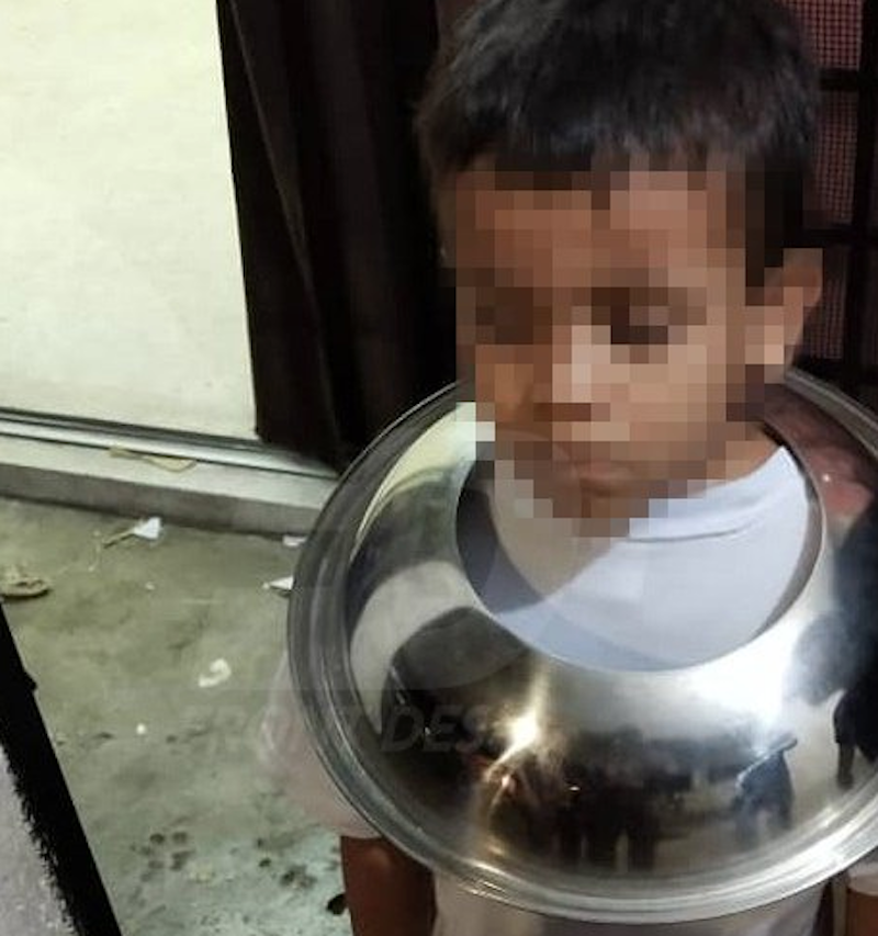 The boy before firefighters used special tools to cut the lid and free his head. u00e2u20acu201d Picture via Twitter/Bernamadotcom