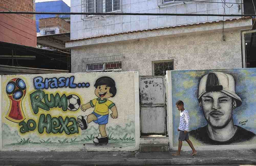 A boy walks by graffitis in Camboata neighbourhood in Rio de Janeiro, Brazil May 31, 2018. u00e2u20acu201d AFP pic