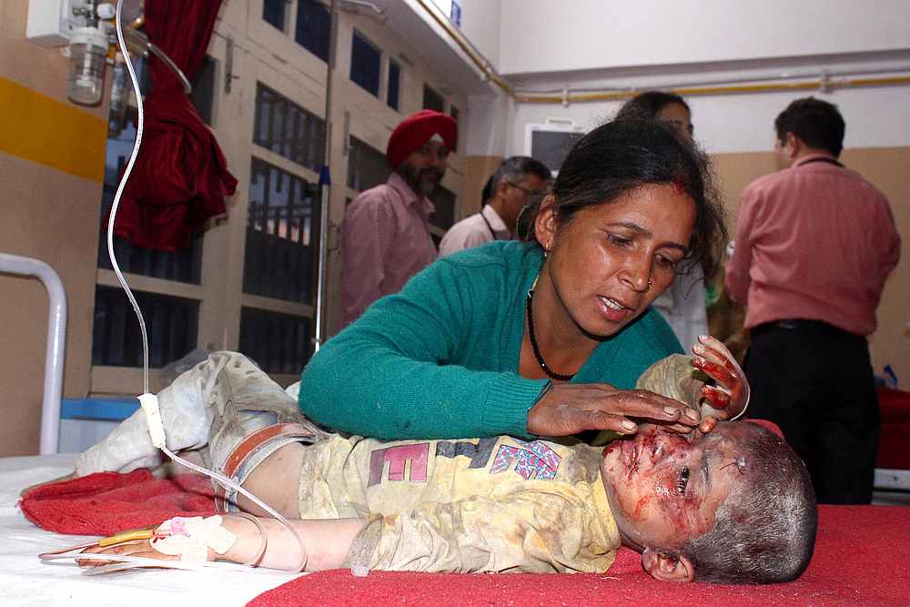 A woman comforts her son who was injured when a bus plunged off a mountain road, at a hospital in Kullu, India June 20, 2019. u00e2u20acu201d Reuters pic