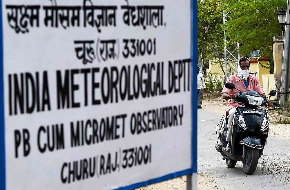 An Indian man rides a scooter as he covers his face to protect himself from the heat outside the India Meteorological Department office in Churu in Rajasthan June 3, 2019. u00e2u20acu201d AFP pic