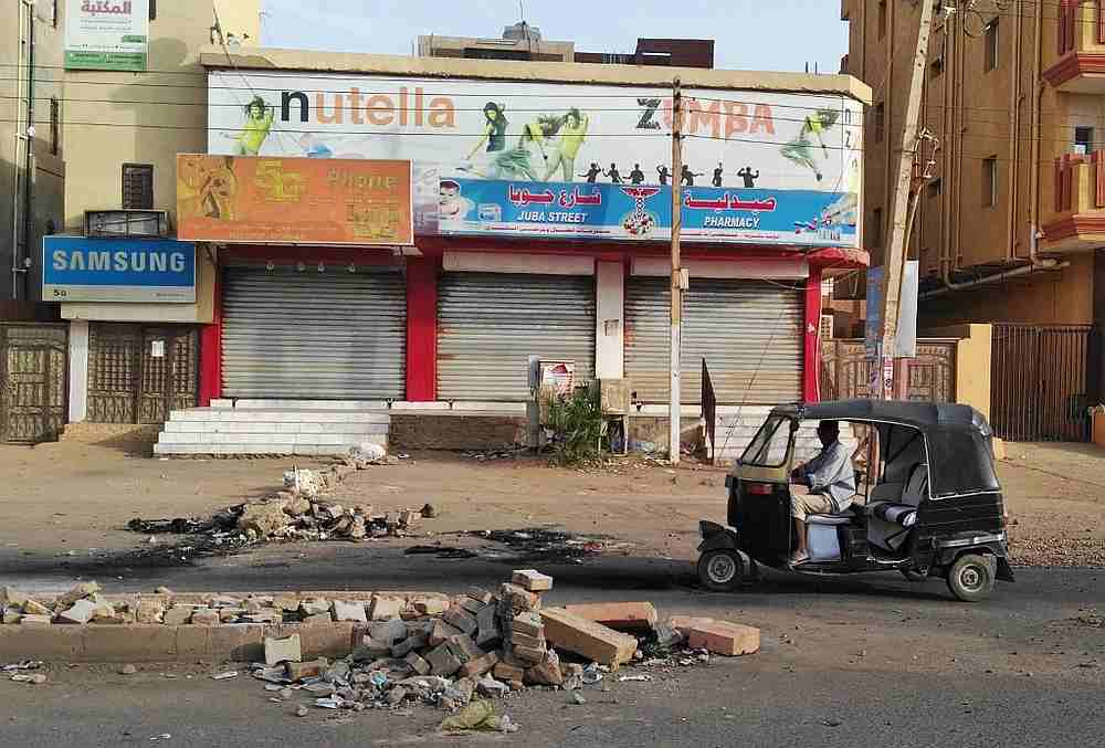 A Sudanese man drives his tuqtuq past closed shops in a residential neighbourhood of Khartoum June 4, 2019. u00e2u20acu201d AFP pic