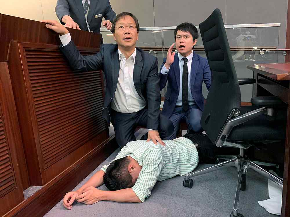 Pro-democracy lawmaker Gary Fan lies down after clashes with pro-Beijing lawmakers during a meeting to consider the controversial extradition bill, in Hong Kong May 11, 2019. u00e2u20acu201d Reuters pic