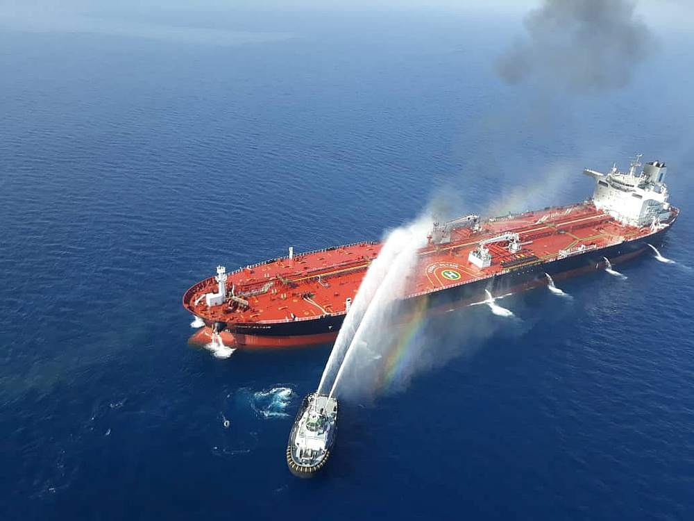 An Iranian navy boat tries to stop the fire of an oil tanker after it was attacked in the Gulf of Oman June 13, 2019. u00e2u20acu201d Tasnim News Agency handout via Reuters
