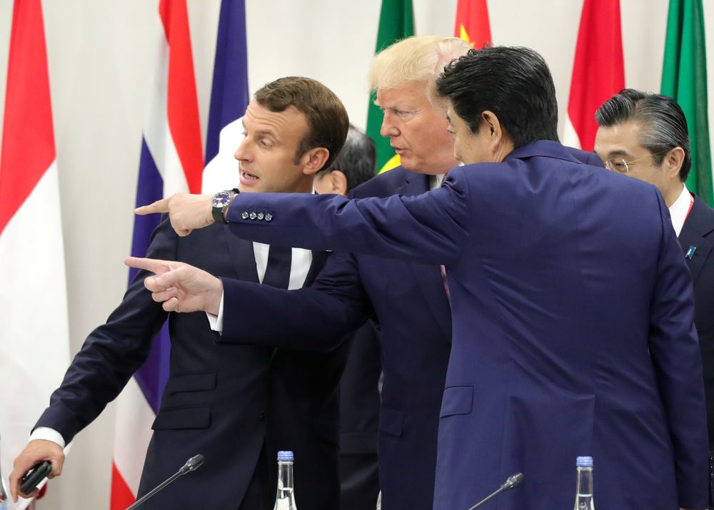 Japanese Prime Minister Shinzo Abe, US President Donald Trump and French President Emmanuel Macron speak during the G20 summit in Osaka, Japan June 28, 2019. u00e2u20acu201d Sputnik/Mikhail Klimentyev/Kremlin pic via Reuters