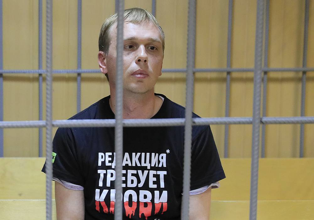 Russian investigative journalist Ivan Golunov sits inside a defendants' cage as he attends a court hearing in Moscow June 8, 2019. The writing on the T-shirt reads 'Editorial desk demands blood.'  u00e2u20acu201d Reuters pic