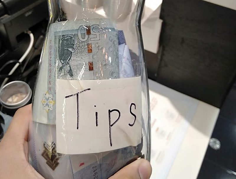 Three Bangladeshi workers tip a Grab driver for sending them back home after three other drivers rejected them. u00e2u20acu201d Picture via Facebook/fadhli.sahar