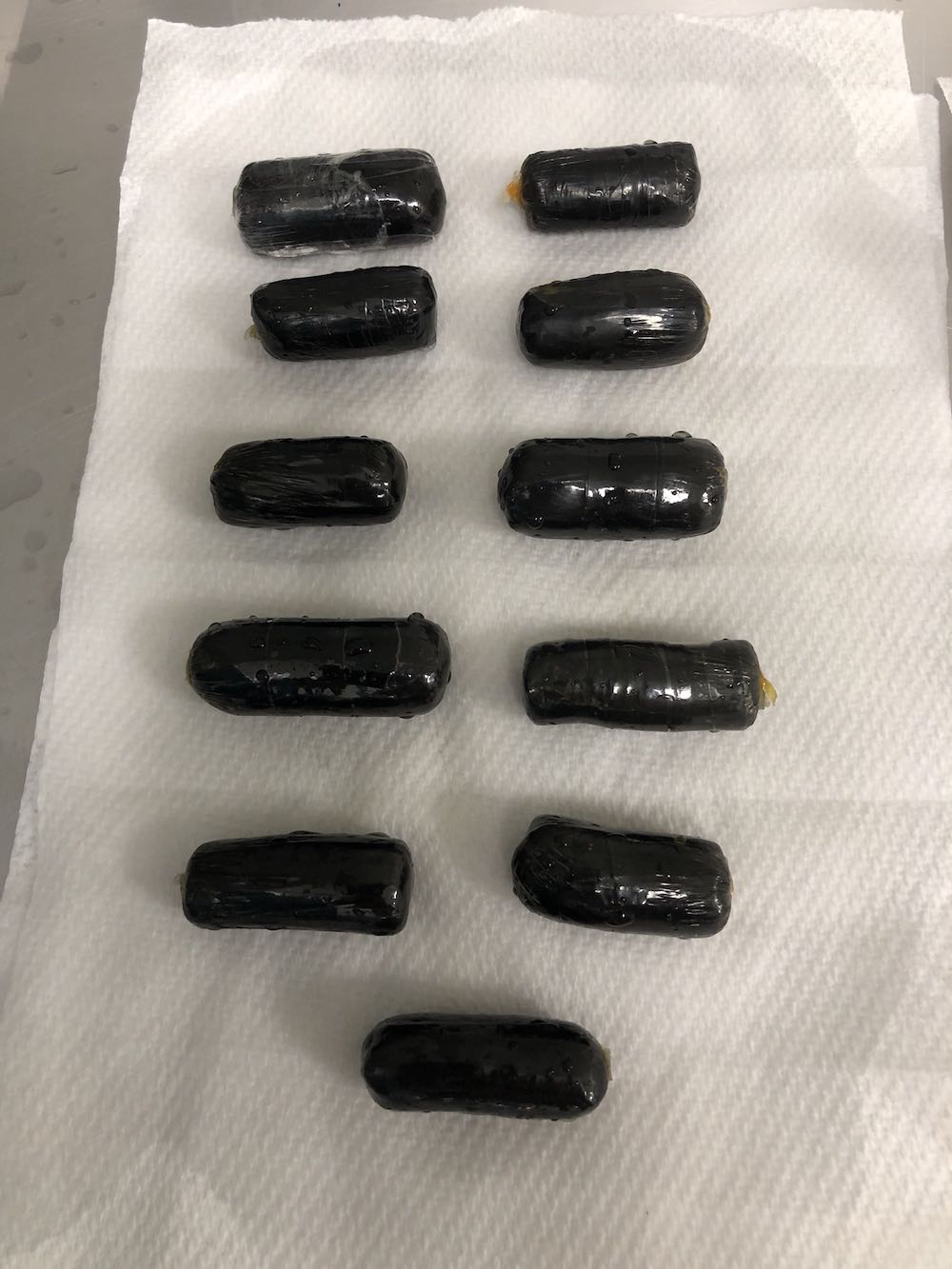 Some of the heroin pellets that were ingested by the Malaysian drug mule. — Australia Federal Police pic