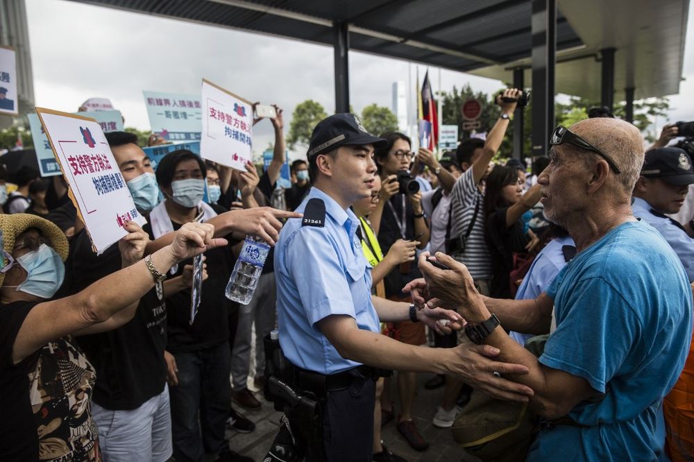 A police officer separates pro-democracy protesters and a pro-Beijing supporter during a rally in support of police in Hong Kong on June 30, 2019. u00e2u20acu201d AFP pic