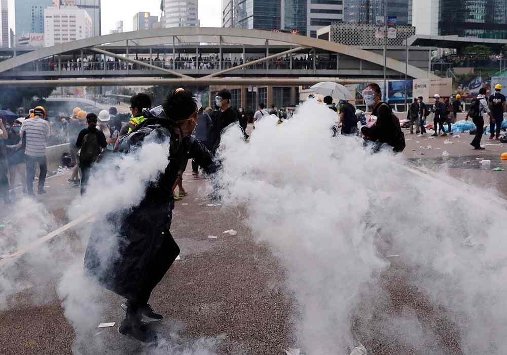 A protester throws a tear gas canister during a demonstration against a proposed extradition bill in Hong Kong June 12, 2019. u00e2u20acu201d Reuters pic
