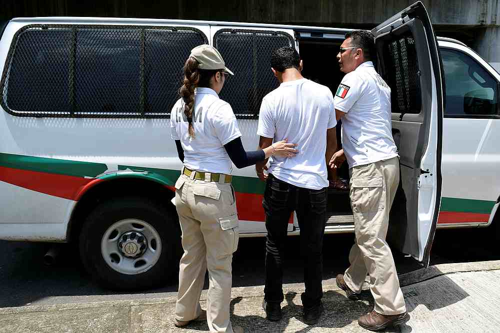 National Migration Institute (INM) escort a detained Honduran migrant at a checkpoint on the outskirts of Tapachula, in Chiapas state, Mexico June 6, 2019. u00e2u20acu201d Reuters pic