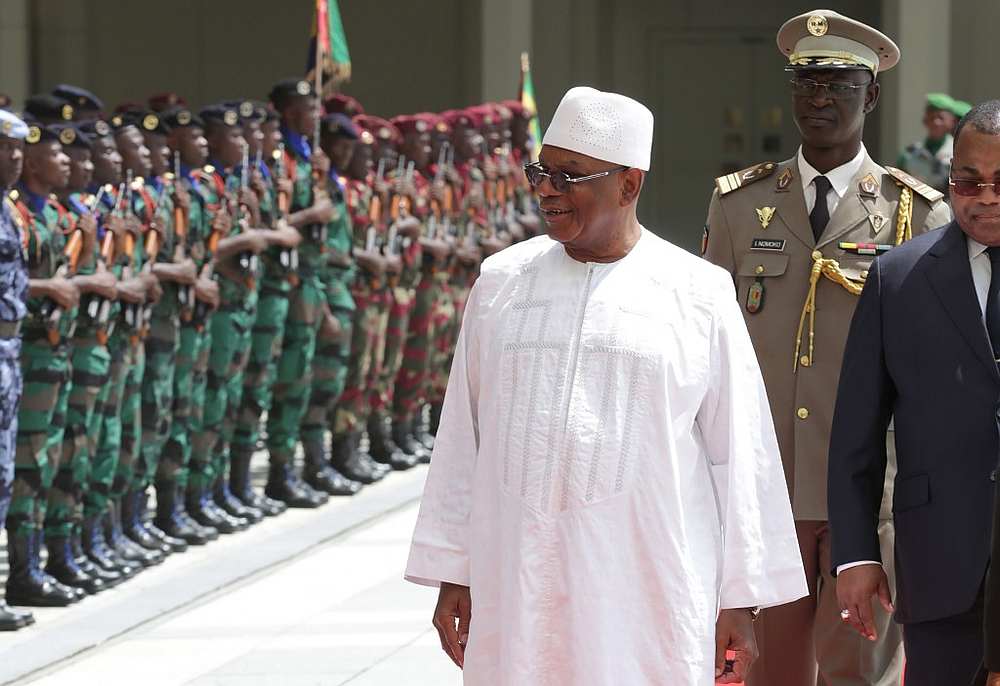 Malian President Ibrahim Boubacar Keita (right) inspects an honour guard in Libreville June 8, 2019. u00e2u20acu201d AFP pic